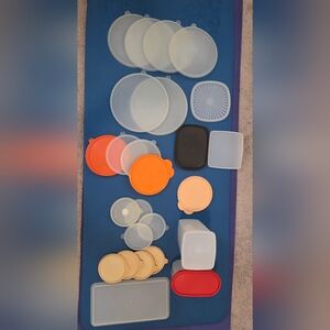 Assorted Tupperware  lids and containers in various sizes and colors.